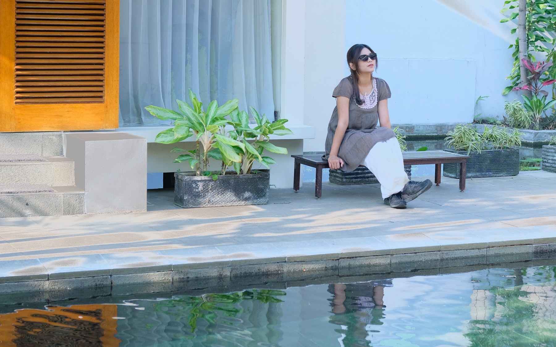 A private pool framed by stone relief